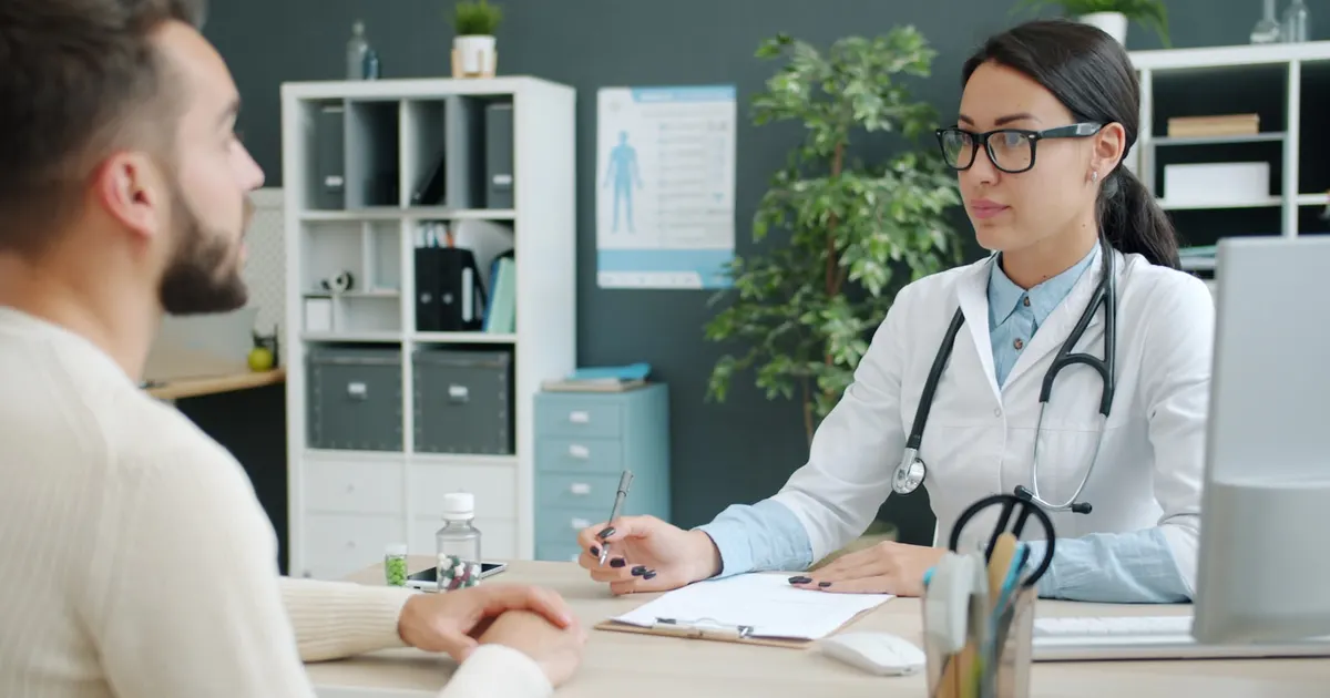 A doctor consulting with a patient in an office